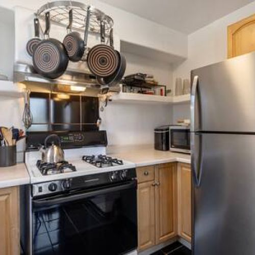 Kitchen includes a stove, fridge/freezer, and all the needed small appliances.