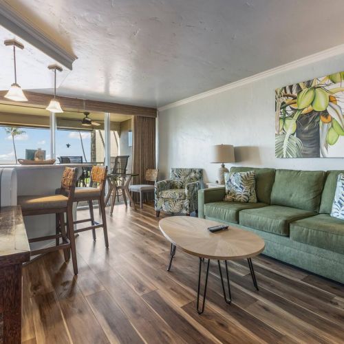 Living area features a queen sofa sleeper, Smart TV with cable, Dyson tower fan, and a sitting chair.