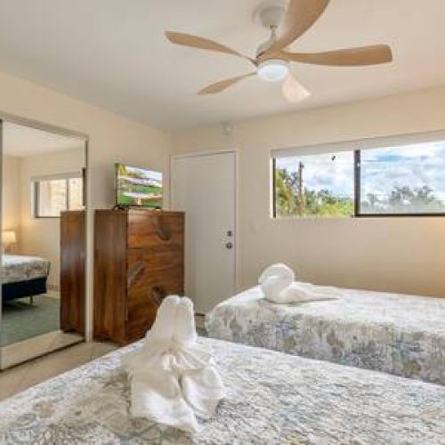 Bedroom 2 features closet space, ceiling fan, central AC, and TV