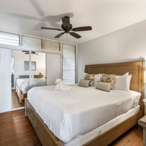 Bedroom features a King size bed, ceiling fan, TV, and clothing storage.