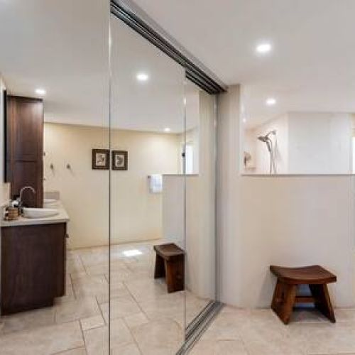 Entrance to the oversized primary bathroom with closet space