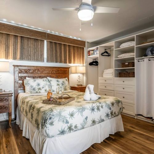 Bedroom features a queen size bed, nightstand phone chargers, California closet, window coverings, and a new ceiling fan.