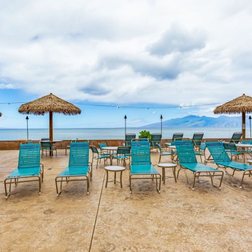 Oceanfront pool area with seating and shade