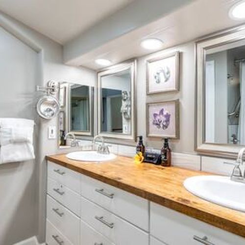 Dual sink vanity, luxury organic essentials, and freshly folded towels.