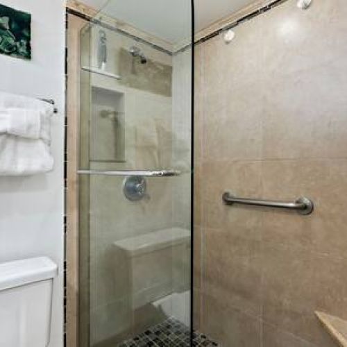 Custom walk in shower, fresh linens, and lux organic bath products courtesy of Stay Aloha