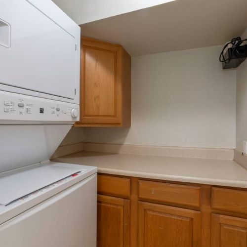 In unit laundry area with washer/dryer and folding space.