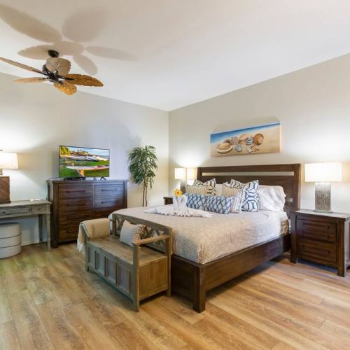 Bedroom features a smart TV with cable and a work desk area..