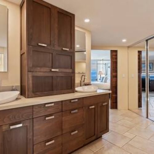 Spacious remodeled primary bathroom with dual sink vanity and custom cabinetry