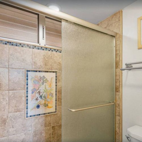 Beautiful walk in shower with ADA handles for easy access.