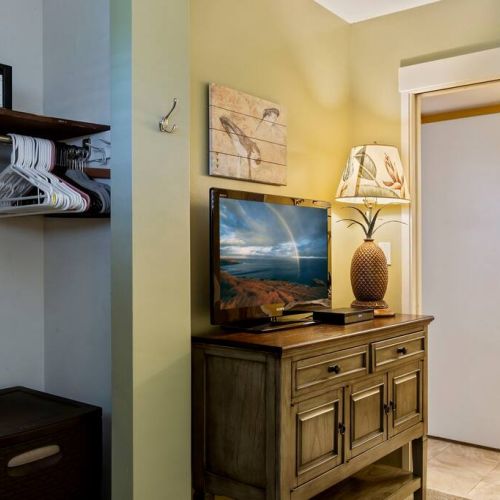 Bedroom features closet with hanger extra storage, ironing board/iron, and a safe.