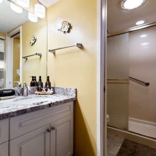 Full bathroom with fresh linens, luxury organic bath essentials, and make up towel.