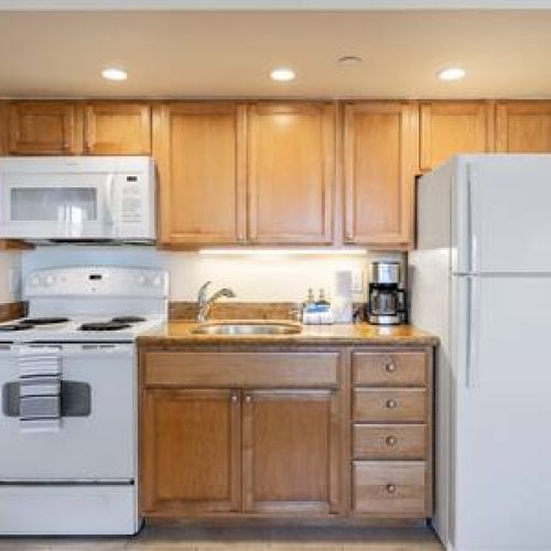 Kitchen features, oven, microwave fridge/freezer, and a coffee maker
