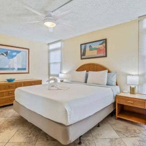 Bedroom features a king size bed, split AC, ceiling fan, window shades, and plenty of storage.