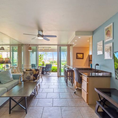 Living room features Smart TV with cable, ceiling fan, sofa sleeper, and designated work desk area.