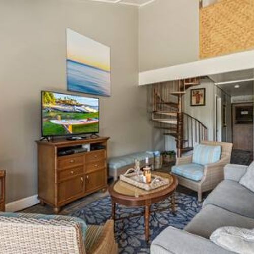 Living area features smart TV with cable, ceiling fan, and plenty of seating