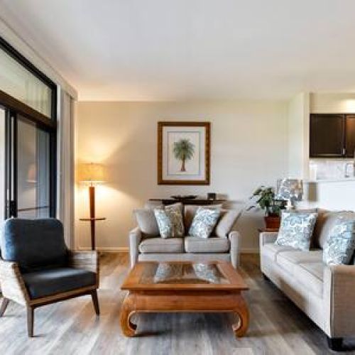 Beautiful coastal style sunken living room leading to lanai