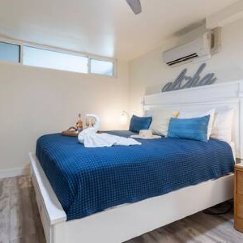 Bedroom features a new King bed, split AC, ceiling fan, and storage