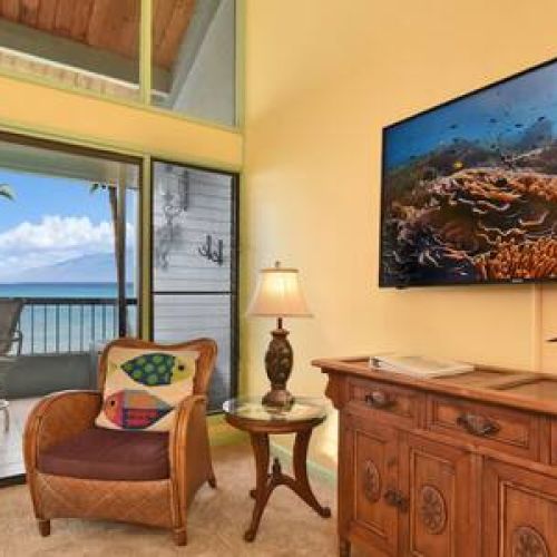 Living room features a large smart TV with cable.