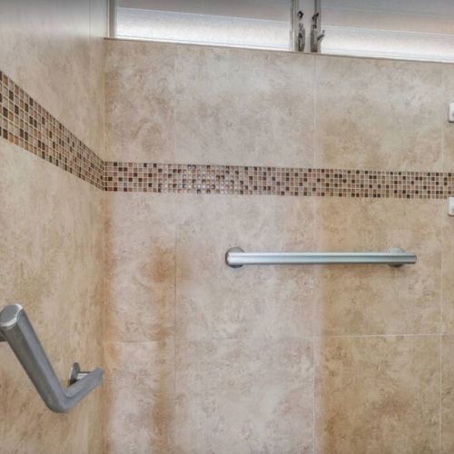 Walk in shower with ADA handles for easy access.