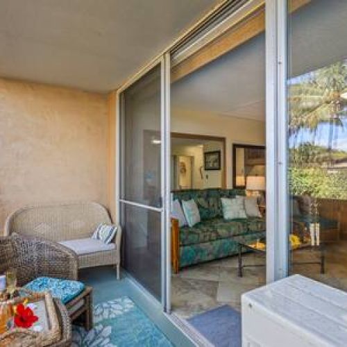 Lanai features 2 sitting chairs and a small loveseat facing ocean.