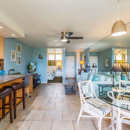 Living room features Smart TV with cable, ceiling fan, sofa sleeper, and designated work desk area.
