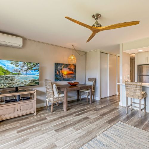 Living room features smart TV, split AC, ceiling fan, and plenty of seating