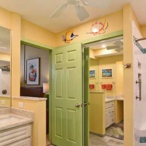 Remodeled bathroom with custom walk in shower, granite single sink vanity, and ceiling fan.