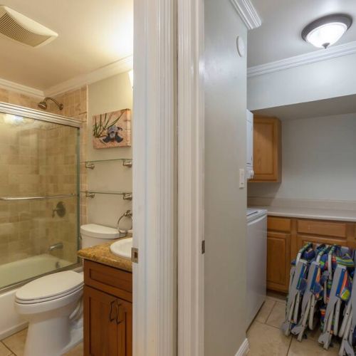 The second bathroom right off the laundry room.